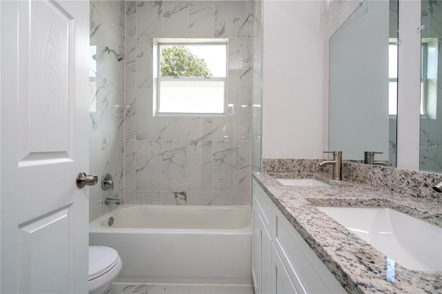 full bathroom with vanity, toilet, and tiled shower / bath combo