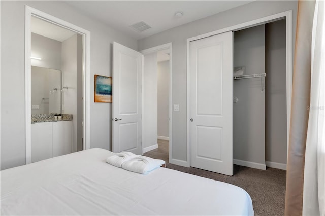 bedroom featuring dark colored carpet and a closet