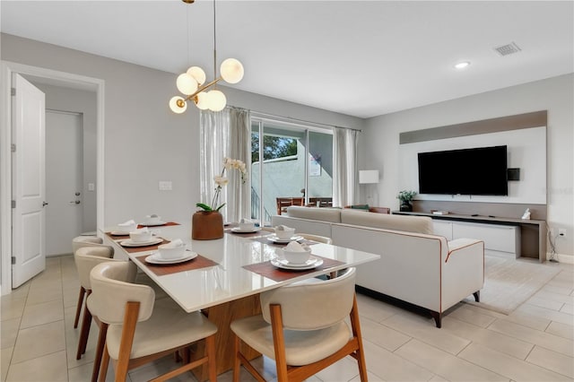 dining room featuring light tile patterned floors and an inviting chandelier