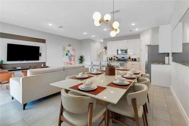 dining room featuring light tile patterned flooring and a notable chandelier