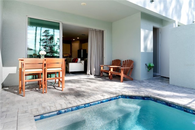 view of pool featuring a patio