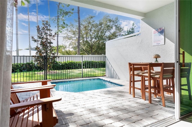 view of swimming pool with exterior bar and a patio area