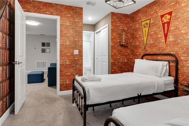 carpeted bedroom with brick wall