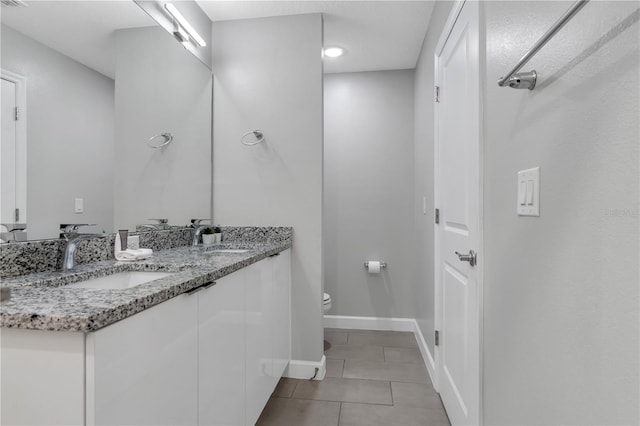 bathroom featuring tile patterned flooring, vanity, and toilet