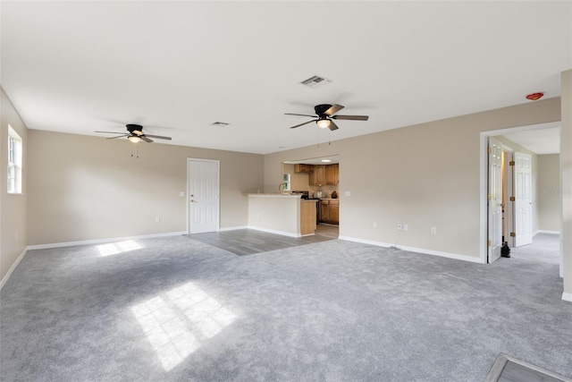 unfurnished living room with light colored carpet and ceiling fan