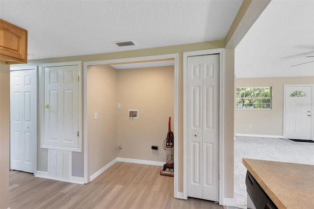 clothes washing area featuring hookup for a washing machine and light hardwood / wood-style floors