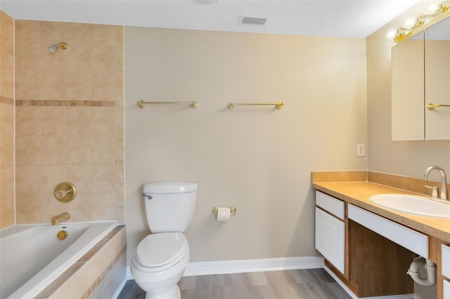 bathroom featuring vanity, hardwood / wood-style floors, and toilet