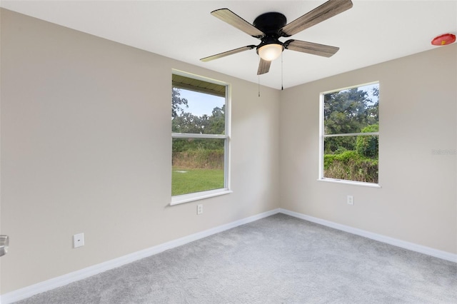 empty room with light colored carpet and ceiling fan