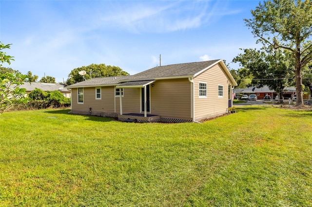 back of property featuring a yard