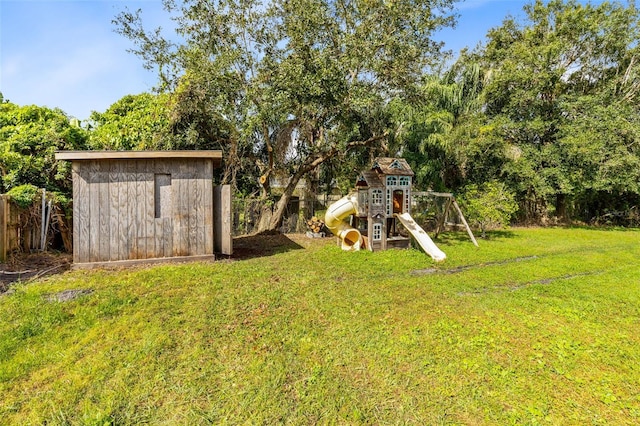 view of yard with a storage unit and a playground