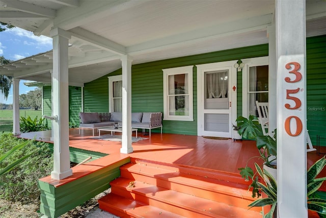 deck with covered porch and outdoor lounge area