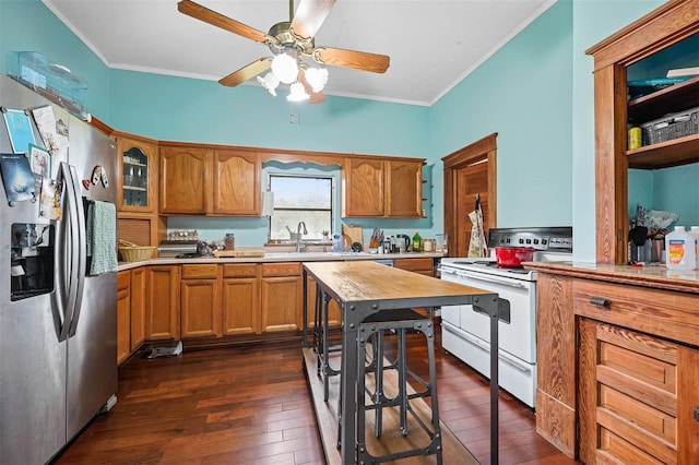 kitchen featuring dark hardwood / wood-style flooring, ornamental molding, white range oven, and stainless steel fridge with ice dispenser