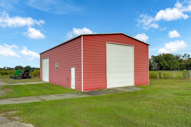 view of outbuilding with a yard and a garage