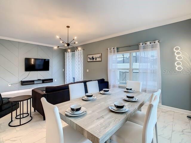 dining space featuring ornamental molding and a notable chandelier