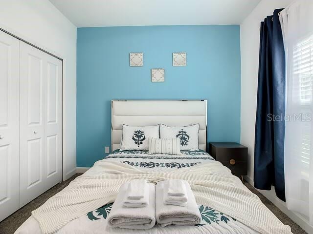 carpeted bedroom featuring a closet