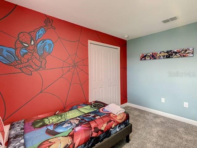 carpeted bedroom with a closet