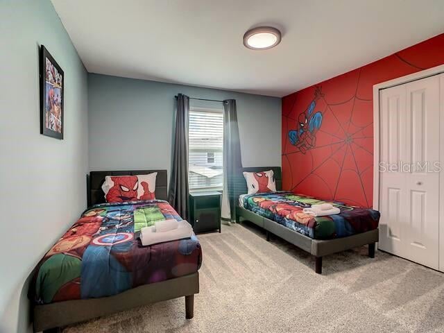 carpeted bedroom featuring a closet