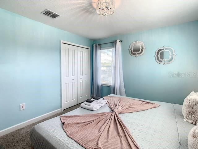 carpeted bedroom with a closet