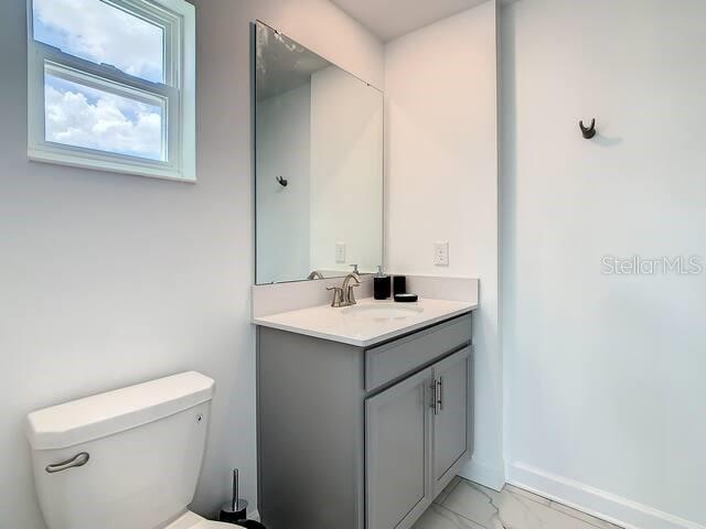 bathroom with toilet and vanity