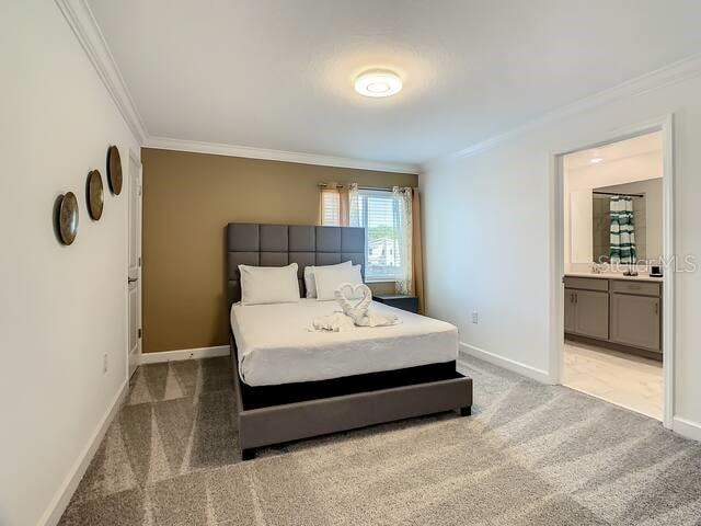 bedroom featuring crown molding, carpet floors, and ensuite bathroom