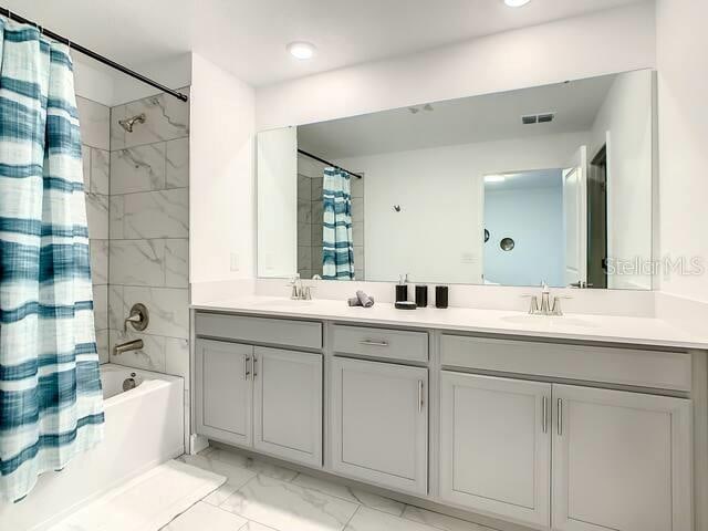 bathroom with vanity and shower / tub combo