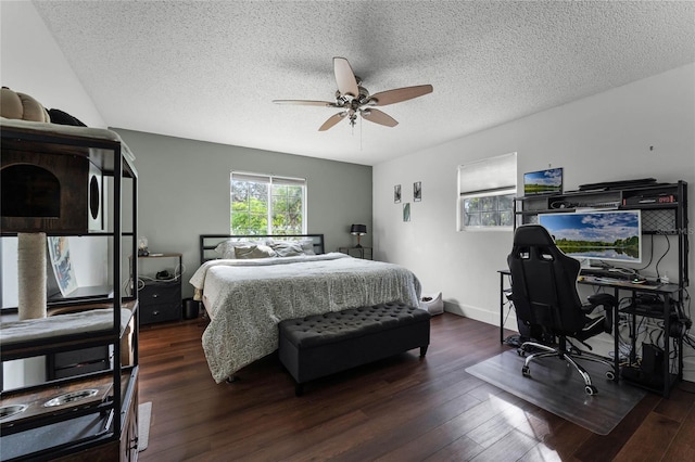 bedroom featuring a textured ceiling, dark wood-type flooring, and ceiling fan