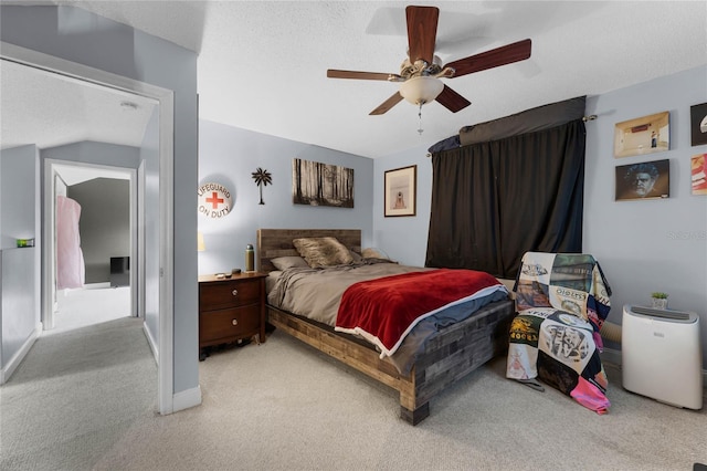 bedroom with light carpet, lofted ceiling, a textured ceiling, and ceiling fan