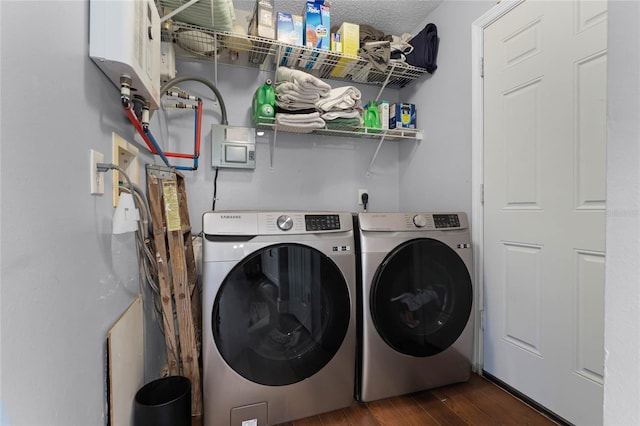 washroom featuring independent washer and dryer, a textured ceiling, and dark hardwood / wood-style flooring