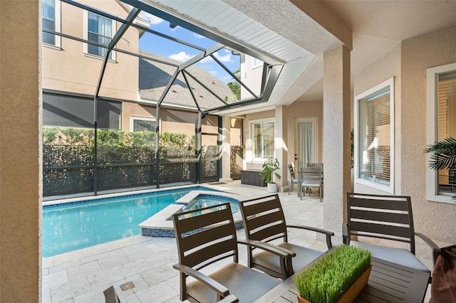 view of pool featuring glass enclosure and a patio