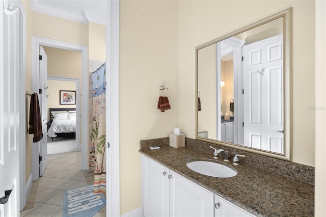 bathroom featuring tile patterned flooring, vanity, and crown molding