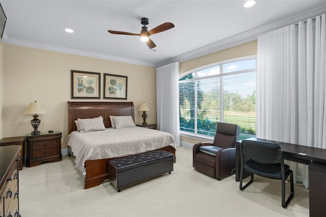 carpeted bedroom featuring ceiling fan and crown molding