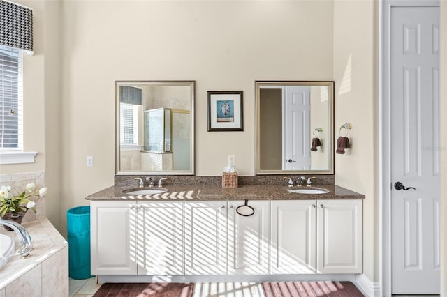 bathroom featuring plus walk in shower and vanity