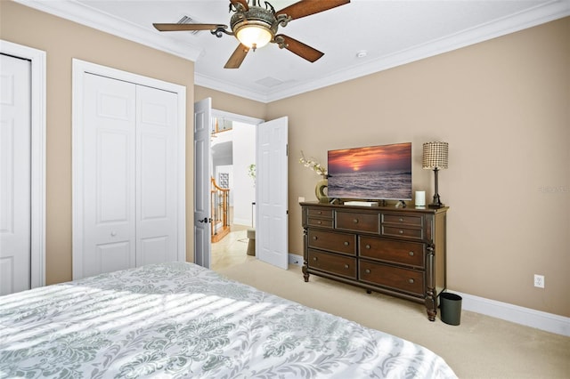 carpeted bedroom featuring ceiling fan, multiple closets, and crown molding