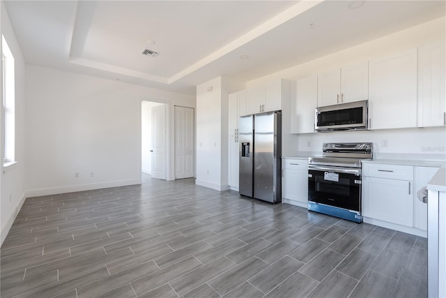 kitchen featuring white cabinetry, hardwood / wood-style floors, and stainless steel appliances