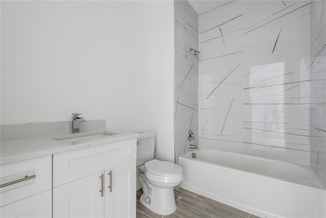 full bathroom featuring wood-type flooring, tiled shower / bath combo, toilet, and vanity