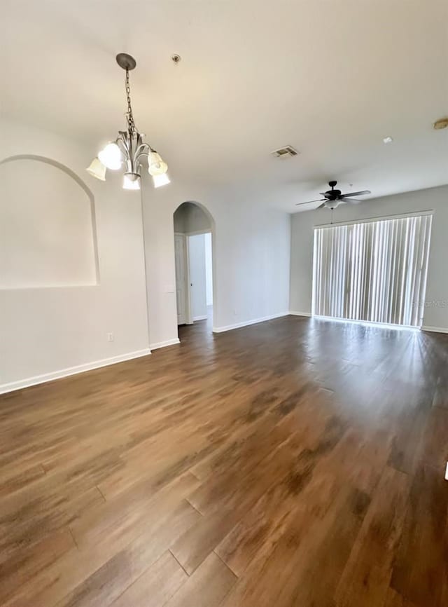 spare room with wood-type flooring and ceiling fan with notable chandelier