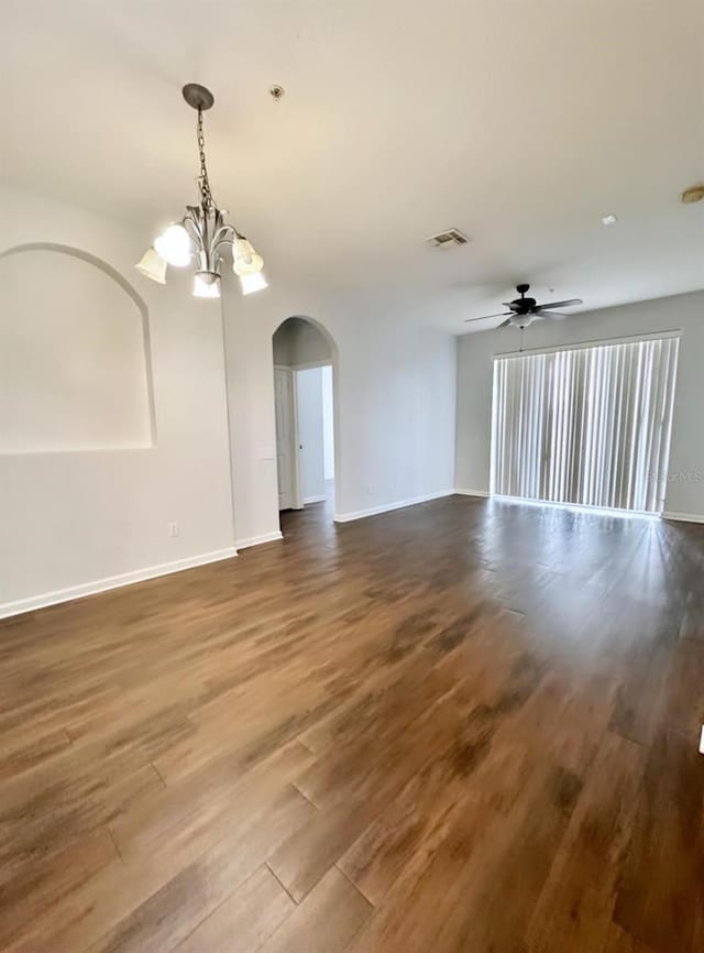 2484 San Tecla Unit 303, Orlando, FL 32835 - spare room featuring wood finished floors, arched walkways, a chandelier, and baseboards