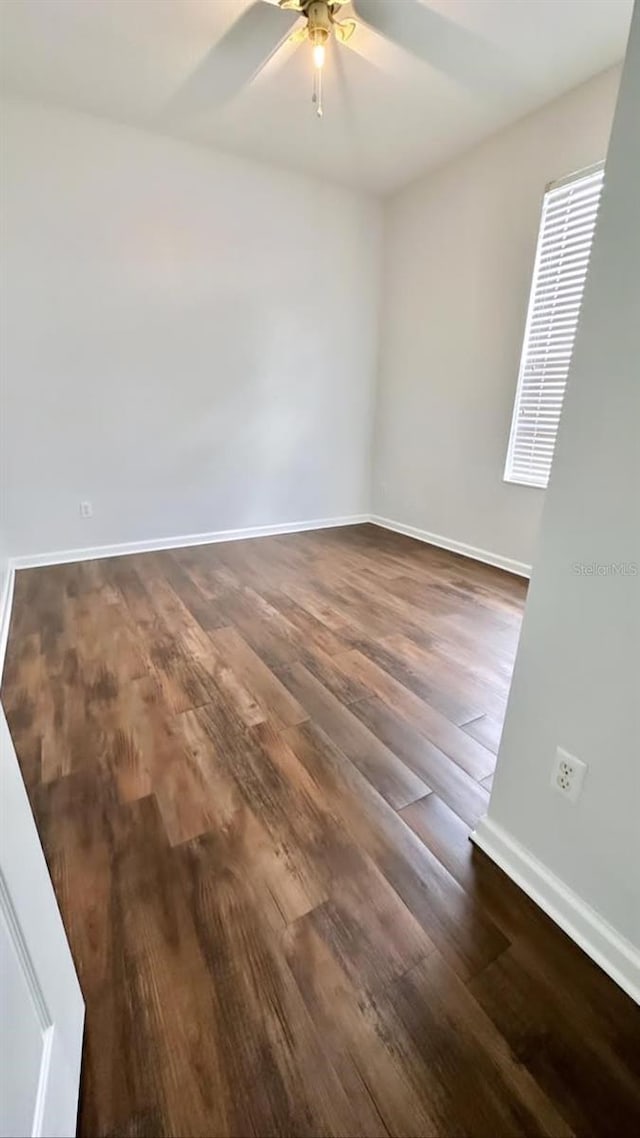 2484 San Tecla Unit 303, Orlando, FL 32835 - spare room featuring baseboards, ceiling fan, and dark wood-style floors