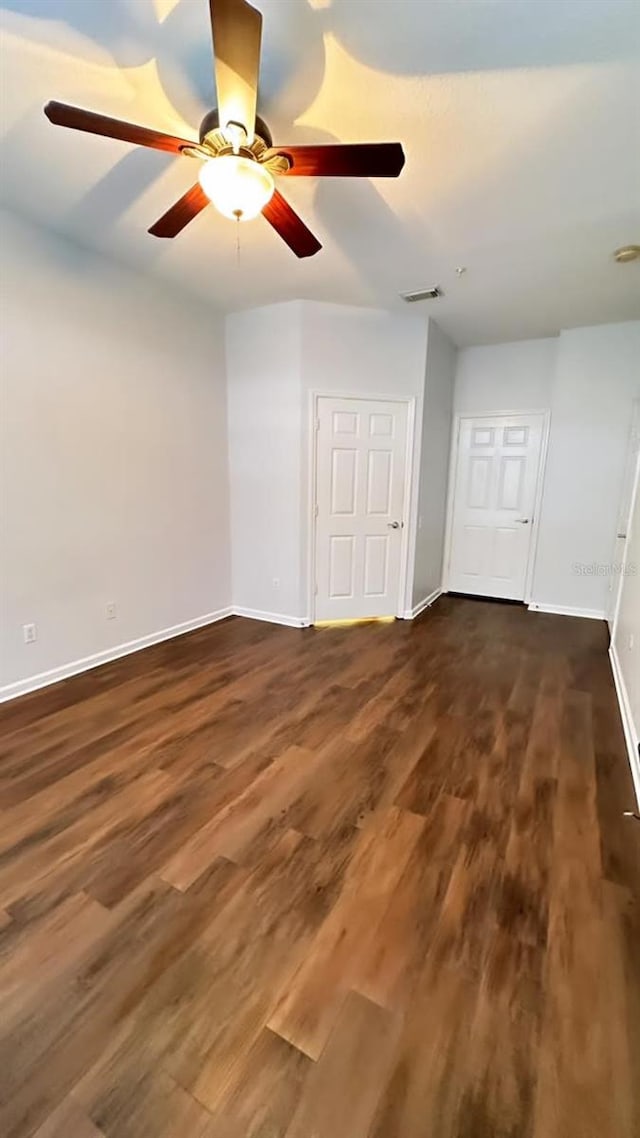 2484 San Tecla Unit 303, Orlando, FL 32835 - spare room with baseboards, dark wood-style floors, and a ceiling fan