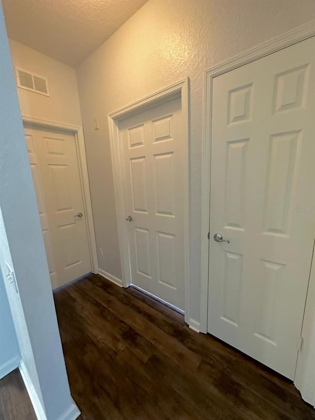 2484 San Tecla Unit 303, Orlando, FL 32835 - hall featuring dark wood-style floors, a textured ceiling, and baseboards