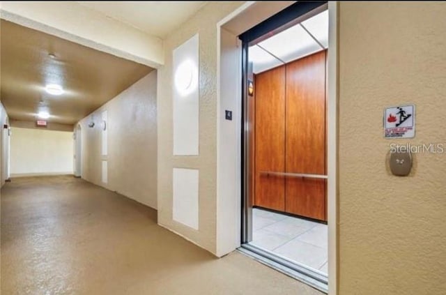 2484 San Tecla Unit 303, Orlando, FL 32835 - hall with a textured wall and elevator