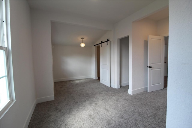 828 Willie Mays Pkwy, Orlando, FL 32811 - spare room with carpet, baseboards, a barn door, and lofted ceiling
