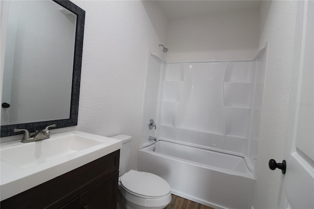 full bathroom with vanity, hardwood / wood-style floors, toilet, and washtub / shower combination