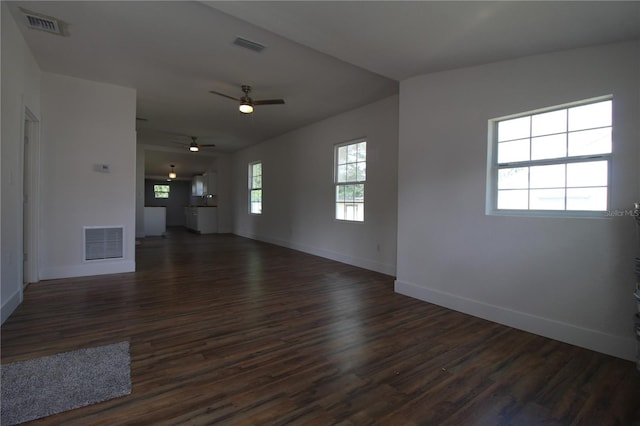 unfurnished living room with dark wood-type flooring, vaulted ceiling, and ceiling fan