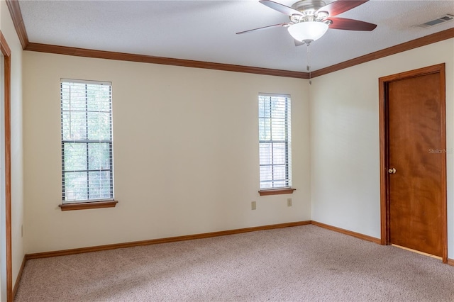 carpeted empty room with ornamental molding and ceiling fan