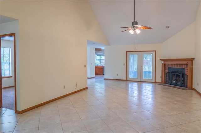 unfurnished living room featuring ceiling fan, high vaulted ceiling, a brick fireplace, and light tile patterned flooring