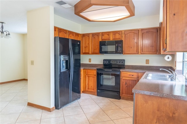 kitchen with sink, light tile patterned floors, and black appliances