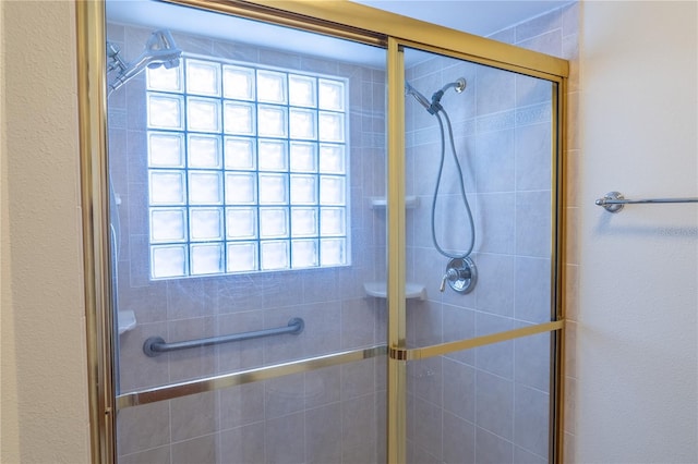 bathroom featuring a shower with door