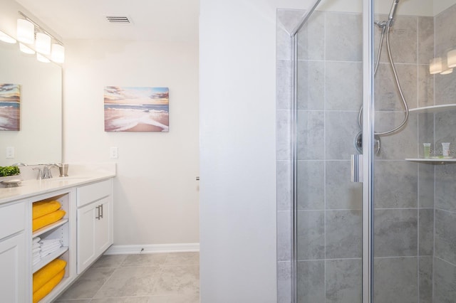 bathroom with vanity, a shower with shower door, and tile patterned flooring