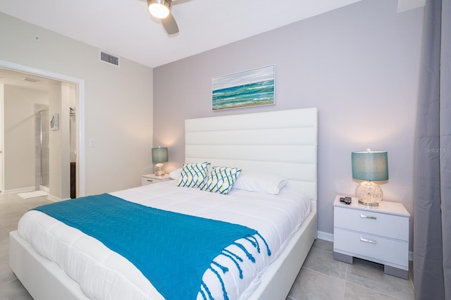 bedroom featuring ensuite bathroom, light tile patterned flooring, and ceiling fan